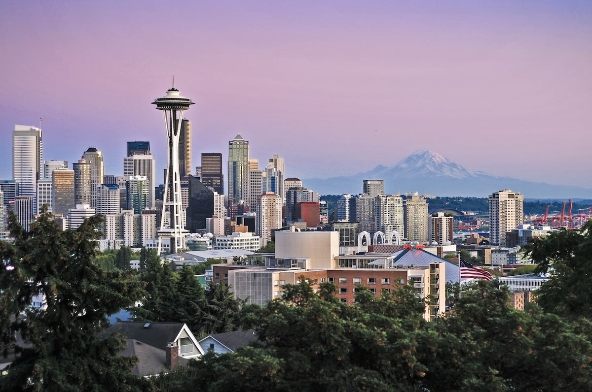 a photo of the iconic Seattle skyline with mount Rainer in the background